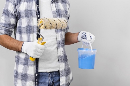 young-man-holding-paint-paint-roller